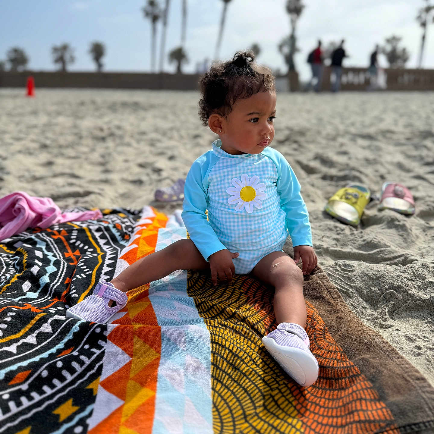 Luxury joined the competition — help win amazing prizes! baby, beach, beachwear, clothing, coast, face, footwear, head, nature, outdoors, person, photography, portrait, sea, shoe, shoreline, shorts, sitting, summer, water