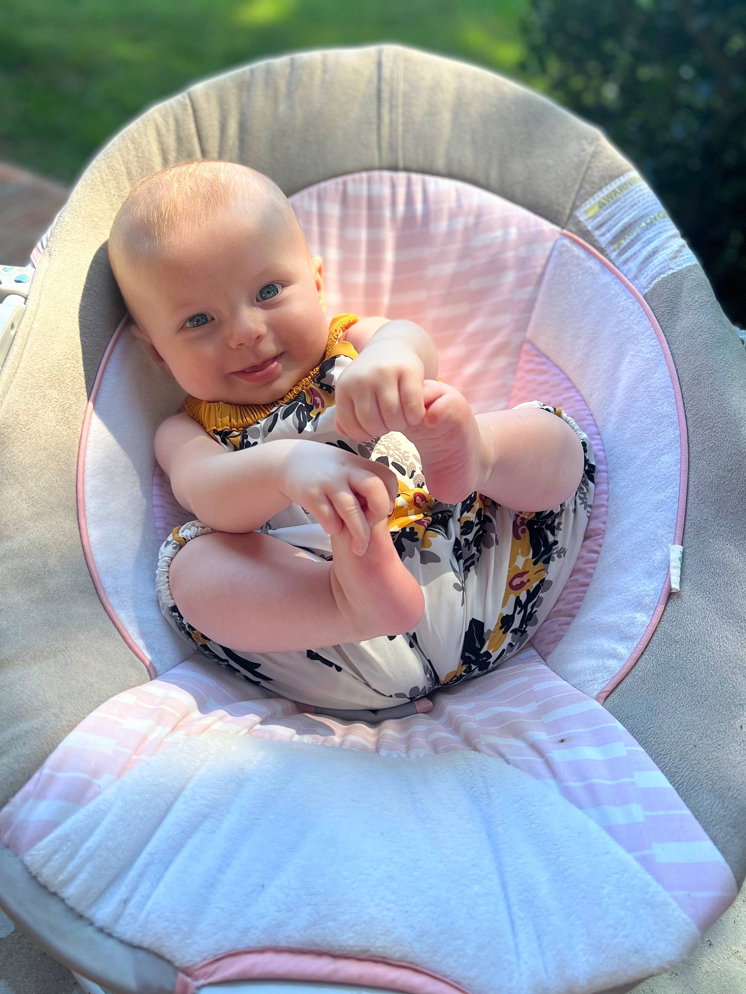 Hattie is registered to the contest to win money with this photo: baby, baby_products, baby_toddler_clothing, chair, child, comfort, event, fun, grass, happy, lap, leisure, outdoor_furniture, person, pink, product, recreation, sitting, smile, thigh
