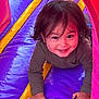 Kosei is registered to the contest to win money with this photo: toddler, child, smiling, crawling, playground, inflatable, bright_colors, purple, yellow, red, happy, fun, play, outdoor, cute, young_child, clothing, person, face, hair