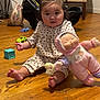 Aera joined the competition — help win amazing prizes! baby, child, doll, toy, pigtails, wooden_floor, indoor, child_playing, furniture, chair, car_toy, baby_clothing, pink, cute, person, floor, home, infant, sitting, playtime