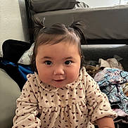 Aera joined the competition — help win amazing prizes! baby, child, indoor, portrait, cute, smiling, dress, pigtails, face, person, bed, clothing, furniture, hair, curious, young_child, sitting, cozy, patterned, room