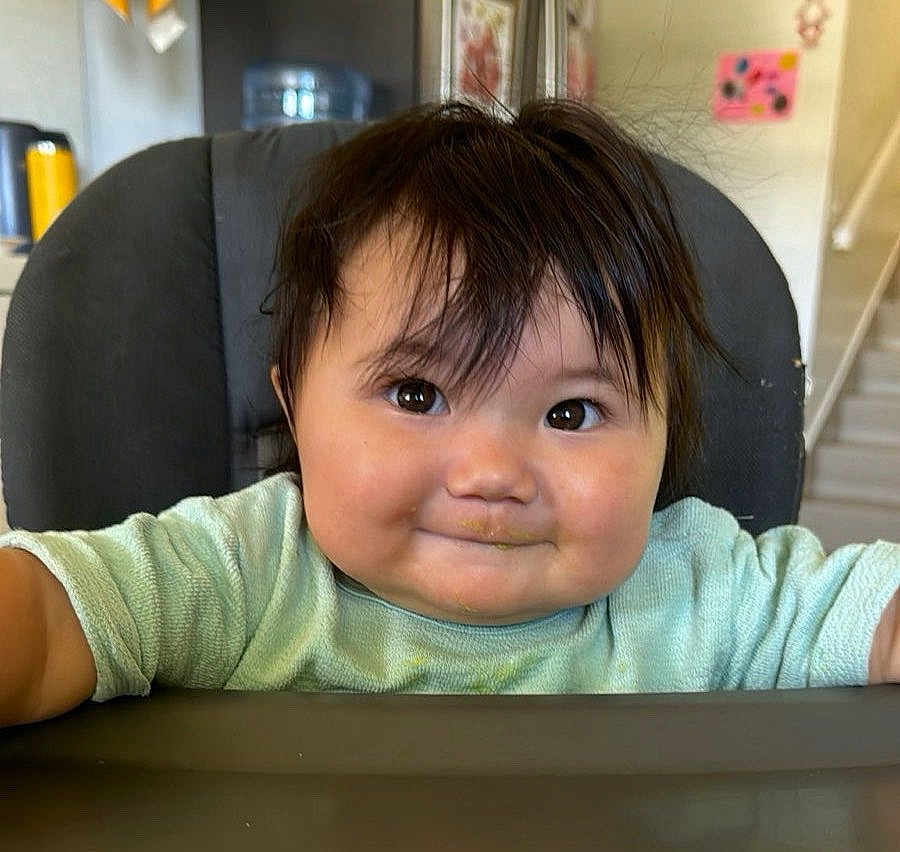 Aera joined the competition — help win amazing prizes! baby, child, high_chair, face, smile, hair, indoor, food_smudge, cheeks, clothing, infant, person, cute, portrait, expression, kitchen, seat, table, young, happy