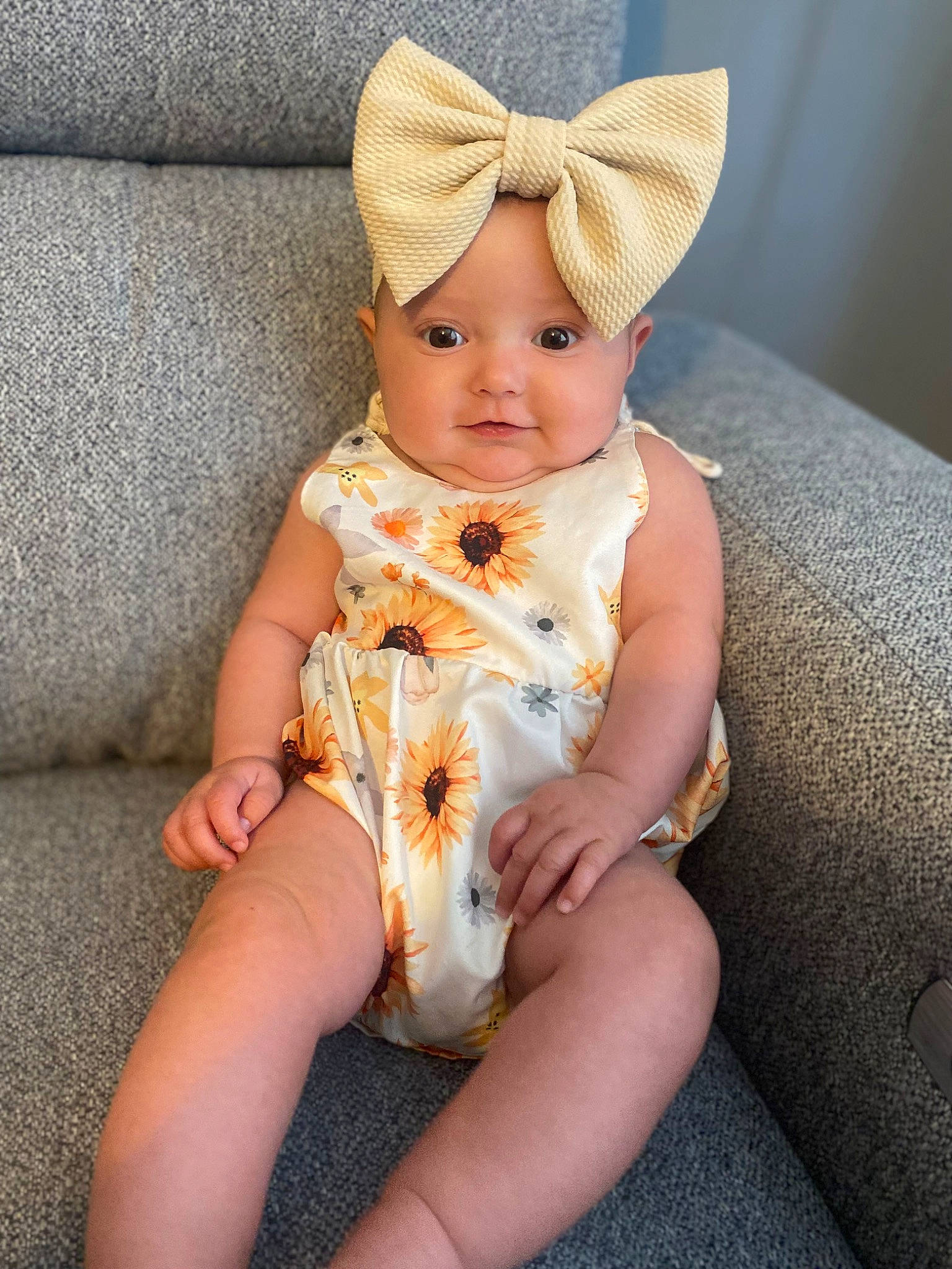 Jurnee is registered to the contest to win money with this photo: baby, baby_toddler_clothing, cap, child, comfort, costume_hat, eye, face, fashion_accessory, foot, head, headgear, headwear, human_leg, knee, lap, linens, person, sitting, skin