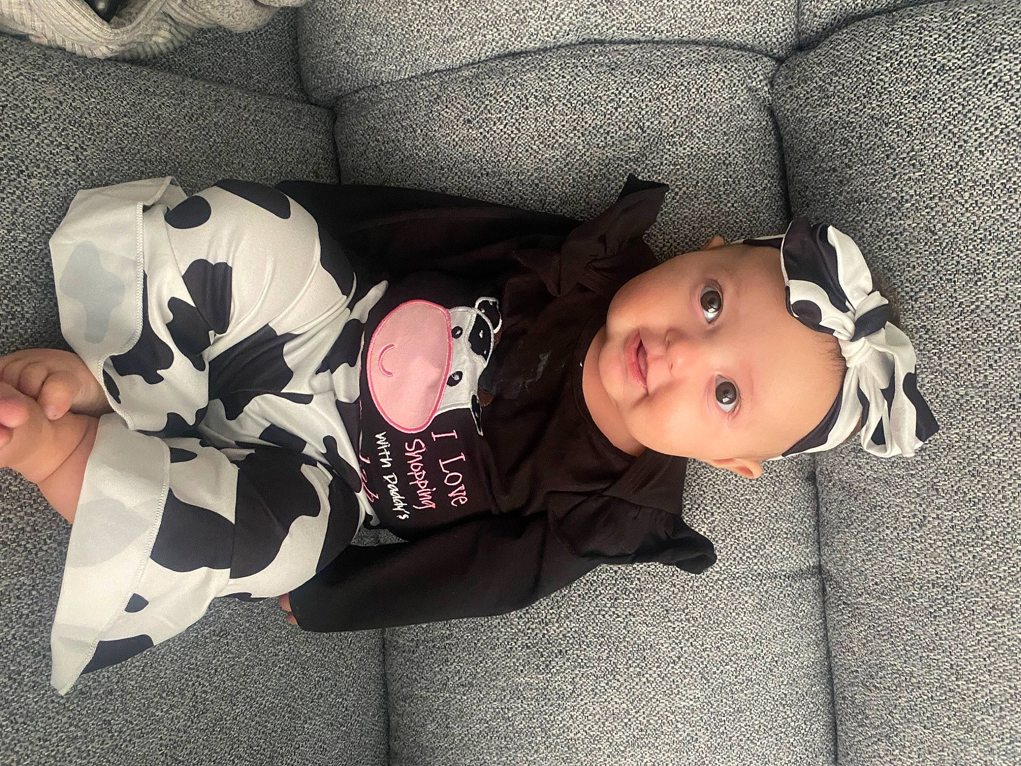 Jurnee is registered to the contest to win money with this photo: baby, baby_products, baby_toddler_clothing, child, comfort, headwear, lap, linens, pattern, person, product, room, sitting, sleeve, toddler, tree