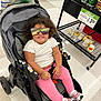 Logann is registered to the contest to win money with this photo: canned_goods, child, curly_hair, floor, grocery_store, happy, indoor, person, pink_leggings, plastic_bag, product_shelf, retail, shopping_cart, smile, sneakers, stroller, sunglasses, toddler, water_bottle, white_shirt
