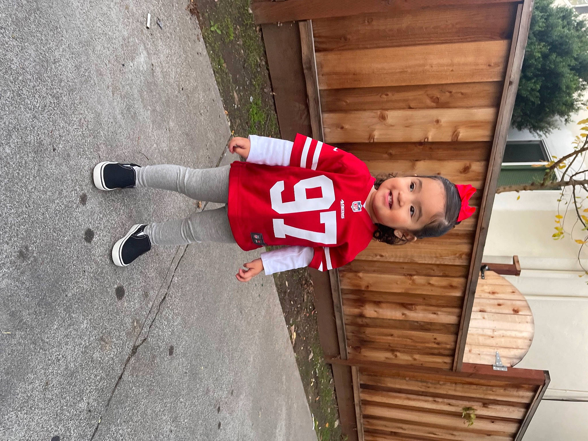 Ariah joined the competition — help win amazing prizes! carmine, child, concrete, fun, grass, hardwood, house, joy, leisure, person, plant, siding, smile, toddler, tree, walking_shoe, window, wood, wood_stain
