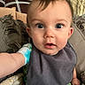 baby, infant, child, portrait, close_up, wide_eyes, sitting, bib, couch, pillows, blanket, home, indoors, face, eyes, brown_hair, clothing, cozy, selfie, photography