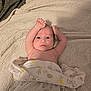 baby, blanket, bed, bedding, person, infant, face, arm, skin, blue_eyes, expression, lying_down, soft_texture, pattern, comfort, sleepwear, cute, indoors, newborn, resting