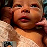 Paizleigh is registered to the contest to win money with this photo: newborn, baby, infant, child, face, portrait, wide_eyes, awake, hands, blanket, swaddled, lying_down, close_up, indoor, soft_lighting, skin, head, photograph, smartphone_screenshot, phone_interface