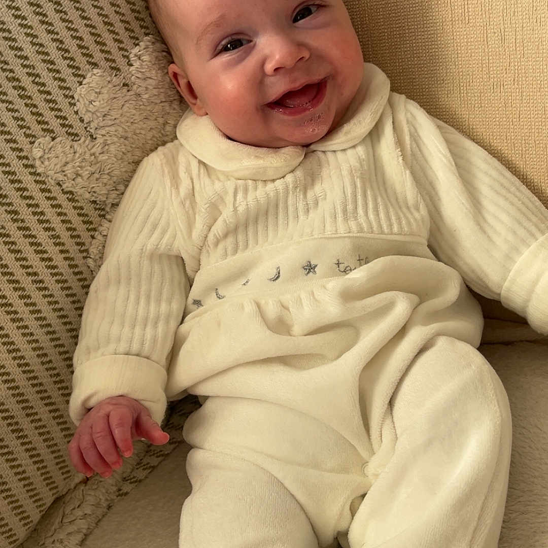Benji joined the competition — help win amazing prizes! baby, babylaughing, bodypart, clothing, couch, cushion, face, finger, furniture, hand, happy, head, homedecor, knitwear, newborn, pants, person, photography, portrait, smile