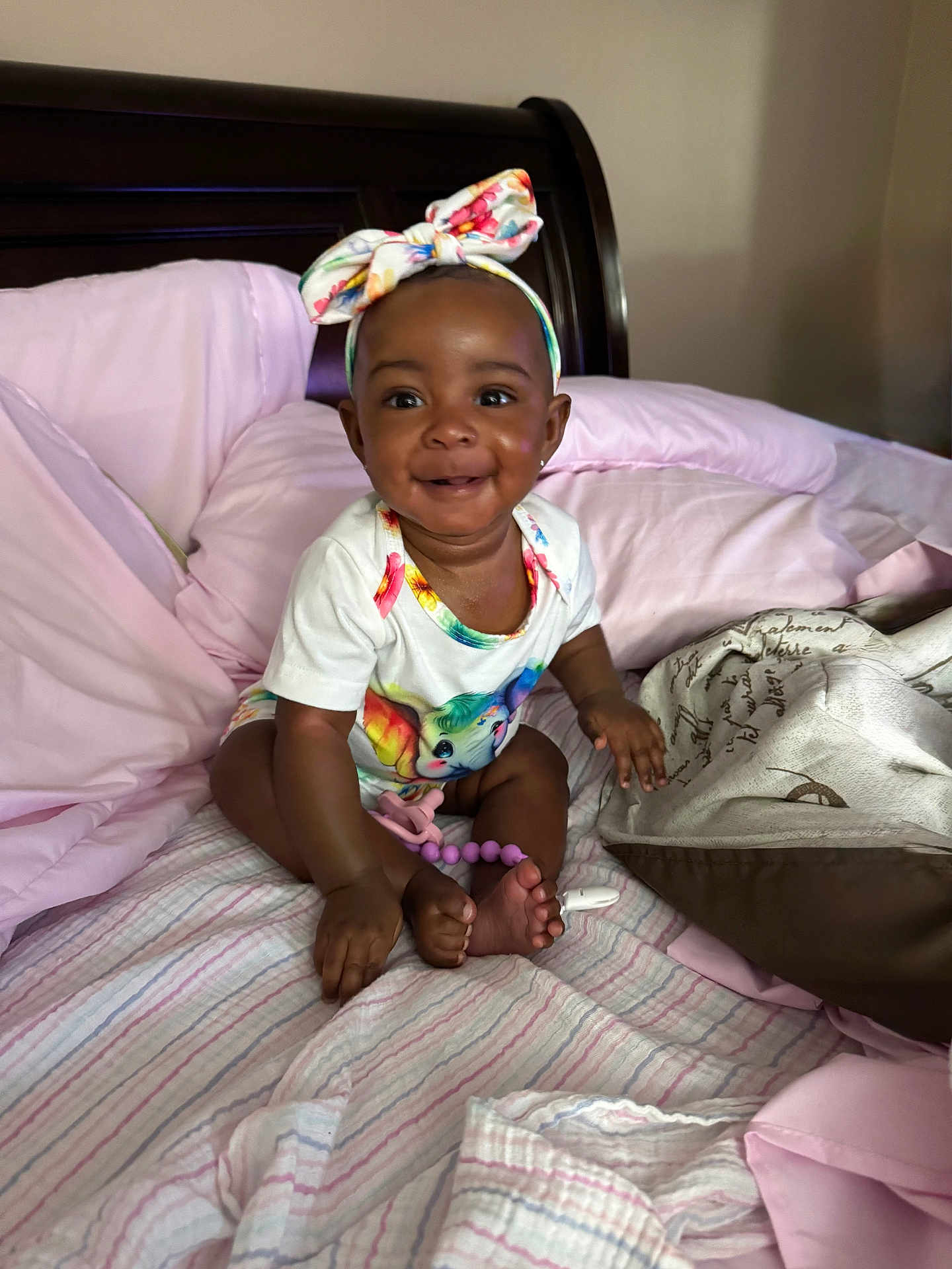 Kymbrielle joined the competition — help win amazing prizes! baby, child, smiling, headband, onesie, unicorn, bed, blanket, pillow, indoor, infant, cute, happy, person, skin, foot, hand, furniture, clothing, portrait