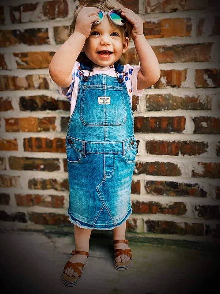 Kaylen joined the competition — help win amazing prizes! blue, child, child_model, clothing, denim, dress, fashion_design, headwear, jeans, one_piece_garment, overall, pattern, person, smile, standing, textile, toddler, turquoise