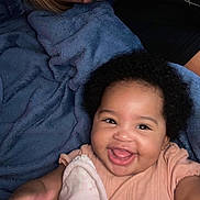 Ariya joined the competition — help win amazing prizes! baby, blanket, child, close_up, comfort, cozy, curly_hair, cute, fun, happy, indoor, infant, joy, lying_down, person, pink_clothing, portrait, smile, soft_texture, warm