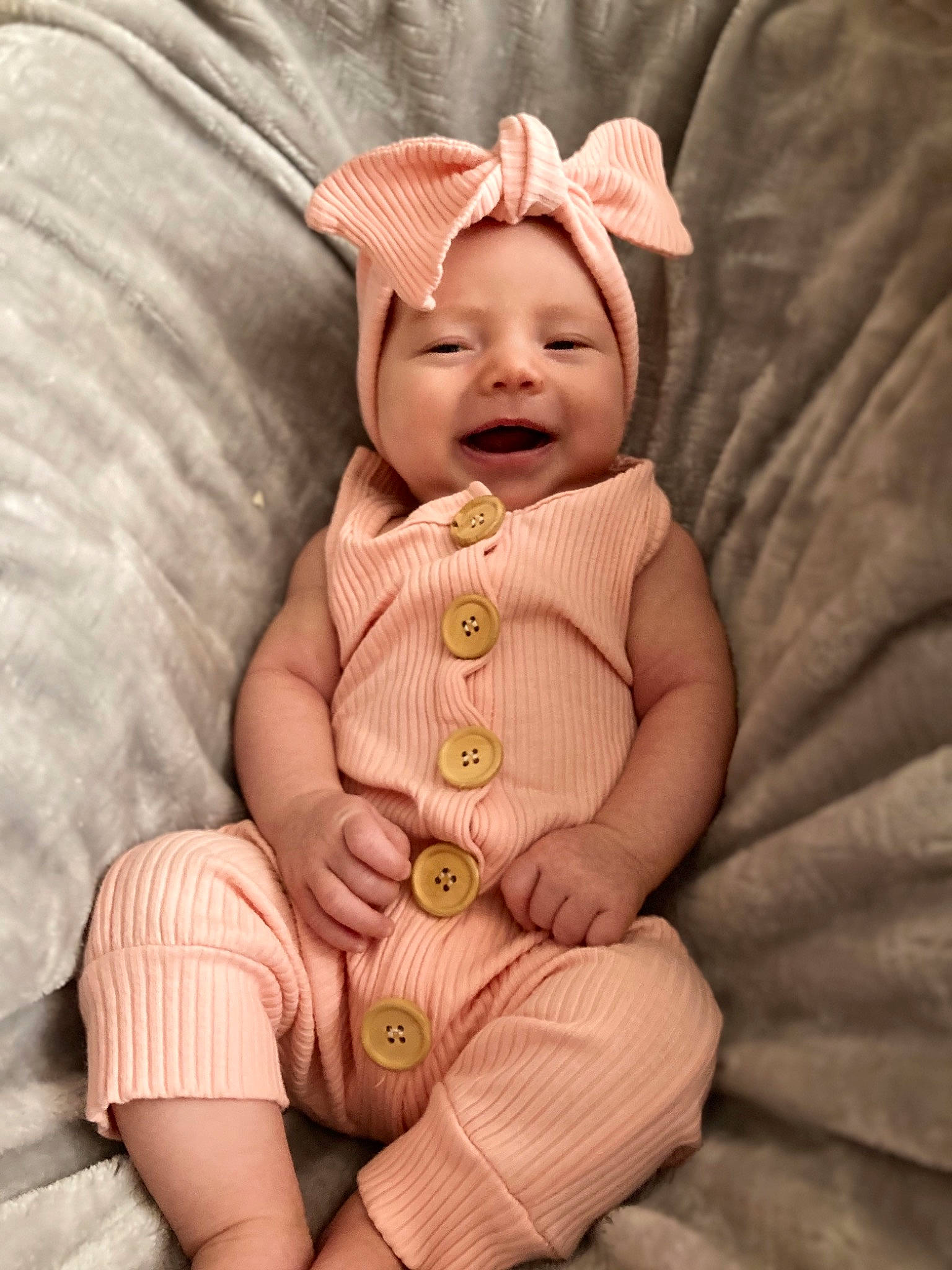 Alyza is registered to the contest to win money with this photo: baby, baby_sleeping, baby_toddler_clothing, cheek, comfort, face, fashion_accessory, finger, happy, hat, headwear, human_leg, linens, pattern, peach, person, sleeve, smile, textile, thigh