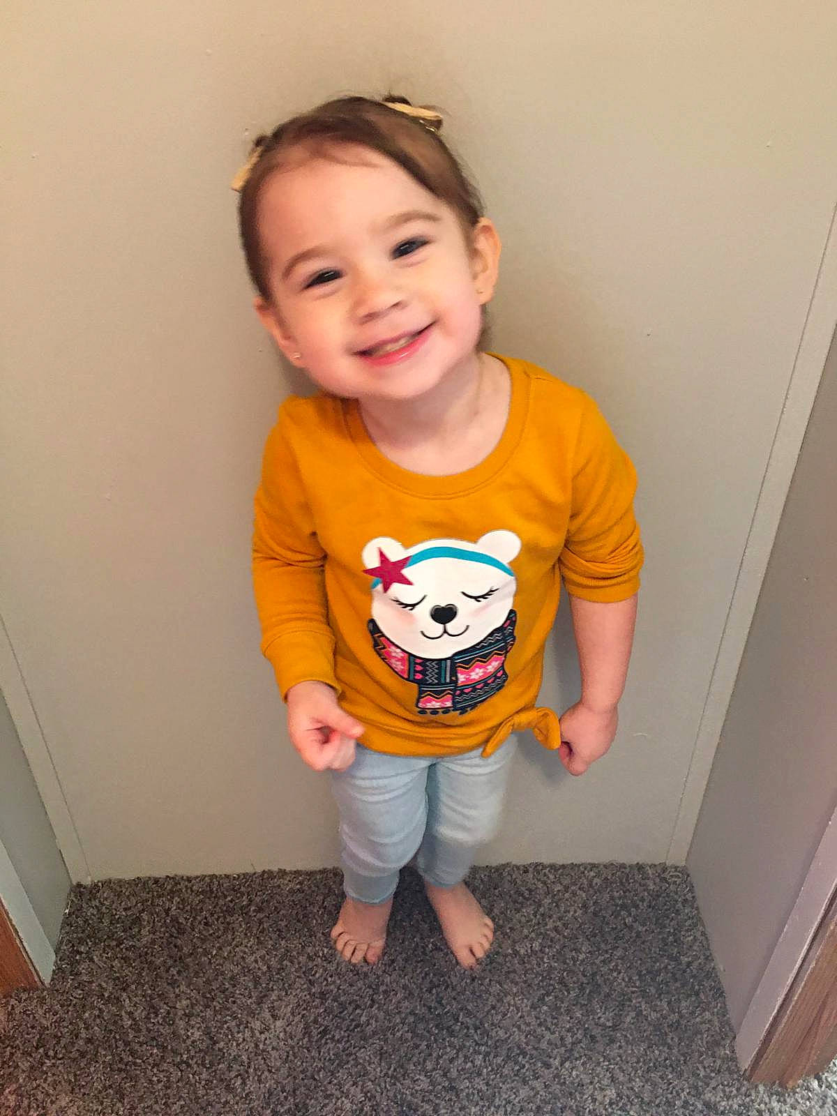 Reyna is registered to the contest to win money with this photo: baby, baby_toddler_clothing, cheek, child, clothing, dress, face, flooring, hair, happy, head, human_body, joy, pattern, person, shorts, skin, sleeve, smile, standing