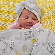Trinity joined the competition — help win amazing prizes! baby, blanket, cozy, crochet, cute, face, headwear, indoors, infant, knitted, newborn, pattern, resting, sleeping, smiling_face, soft, towel, white, wrapped, yellow