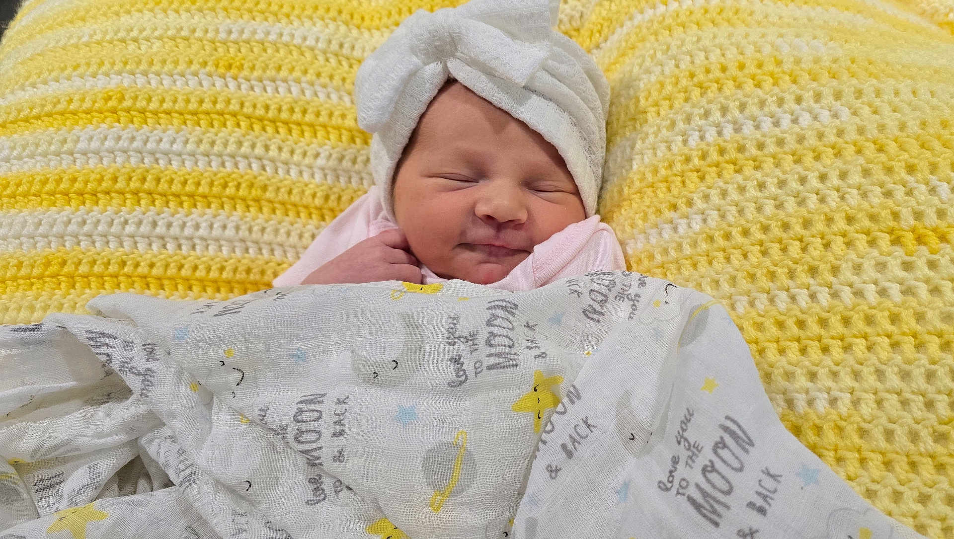 Trinity joined the competition — help win amazing prizes! baby, blanket, cozy, crochet, cute, face, headwear, indoors, infant, knitted, newborn, pattern, resting, sleeping, smiling_face, soft, towel, white, wrapped, yellow