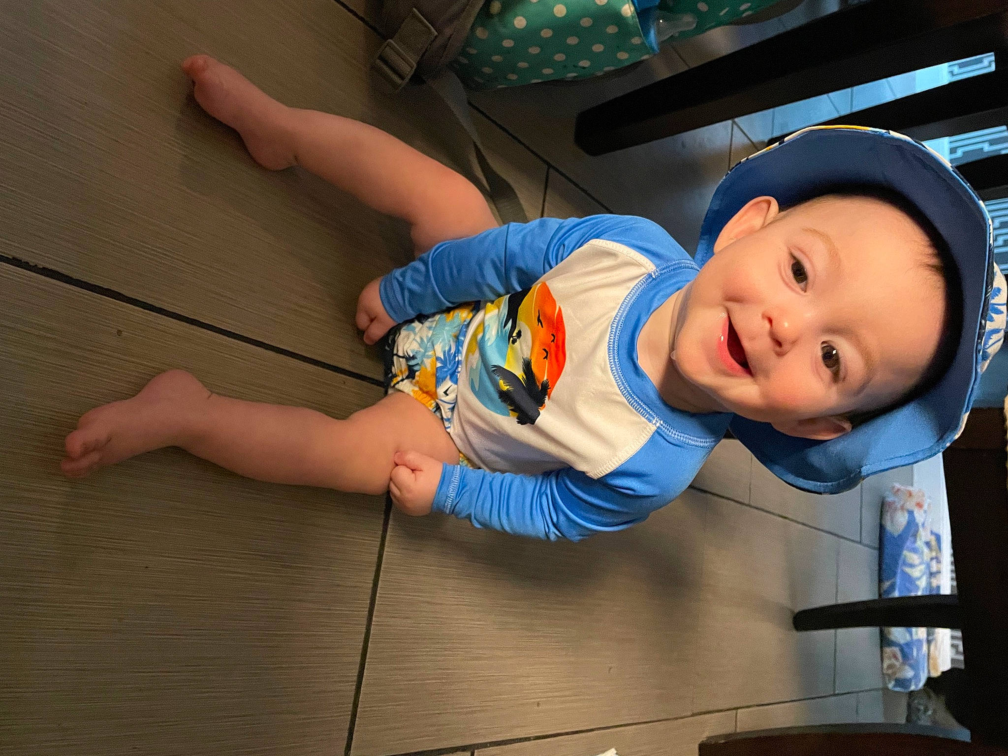 Giovanni is registered to the contest to win money with this photo: baby_toddler_clothing, baseball_cap, cap, child, elbow, electric_blue, flash_photography, flooring, fun, happy, hat, human_leg, joy, knee, leisure, person, sitting, smile, t_shirt, thigh