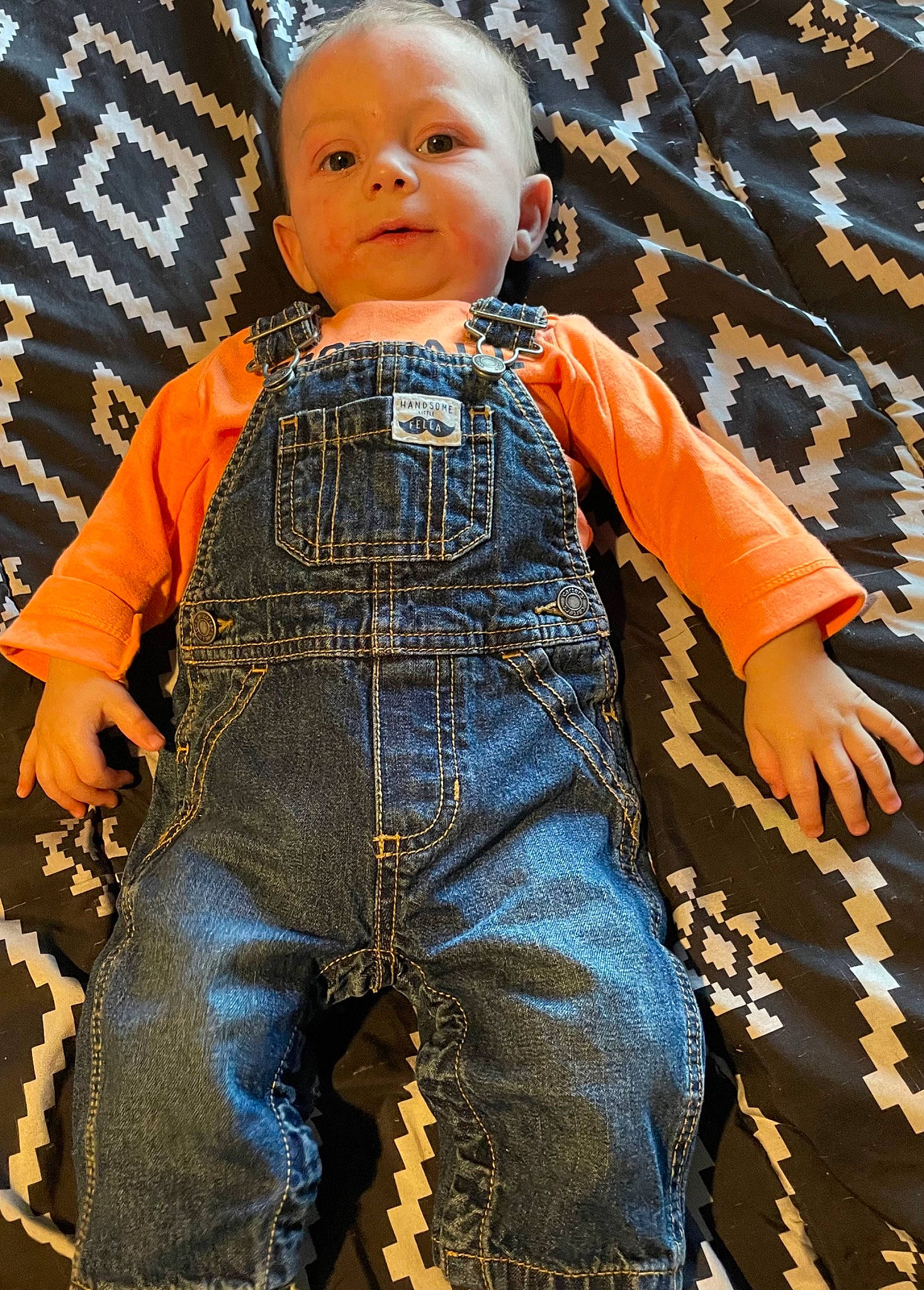 Leonardo is registered to the contest to win money with this photo: abdomen, arm, baby, baby_toddler_clothing, child, denim, electric_blue, fashion_design, flooring, fun, hand, happy, orange, pattern, people_in_nature, person, portrait_photography, sitting, sleeve, toddler