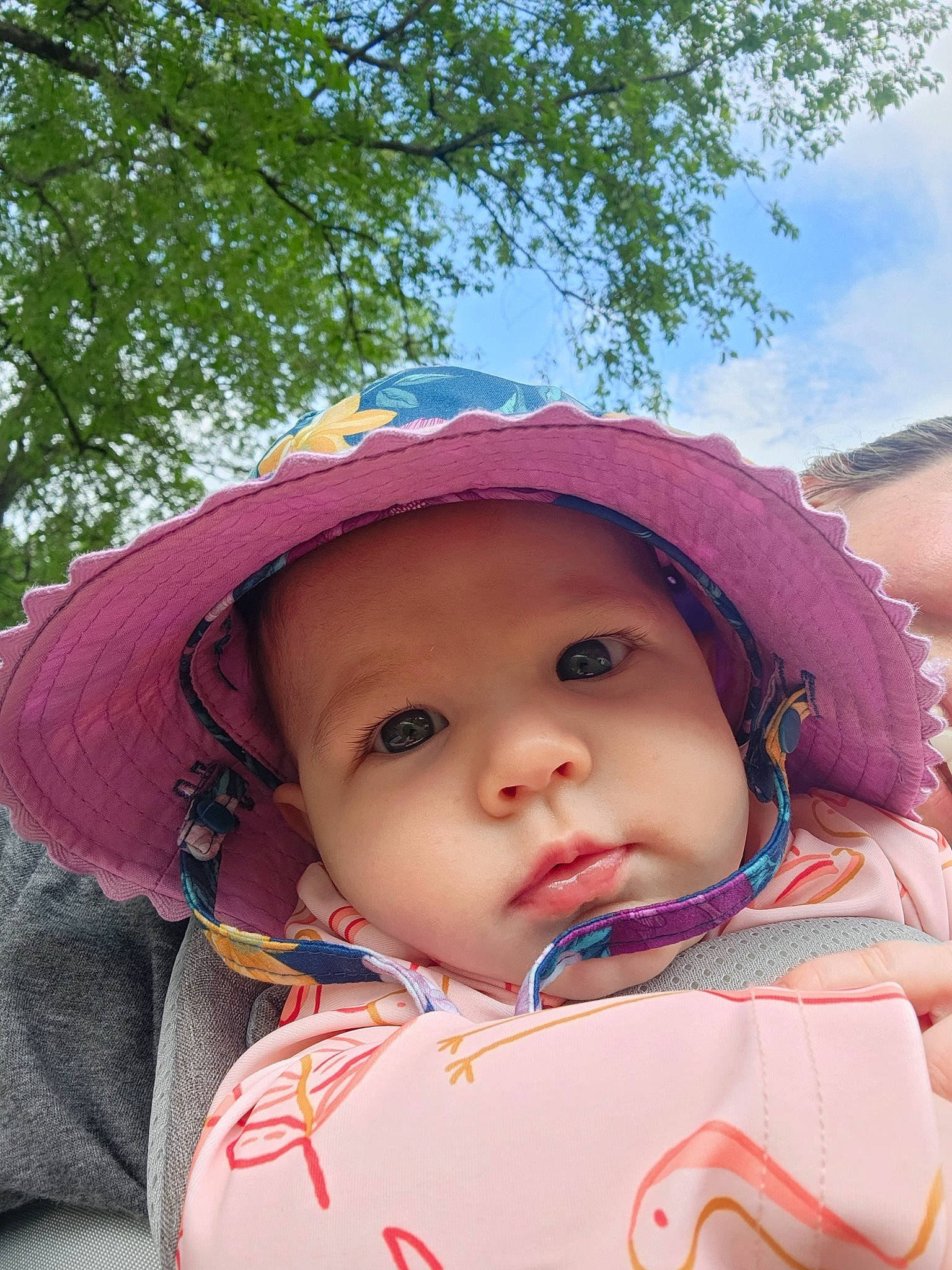 Lucy joined the competition — help win amazing prizes! baby, cap, cheek, chin, eye, face, happy, hat, headgear, headwear, human_body, lip, mouth, nose, person, pink, plant, skin, sky, sun_hat