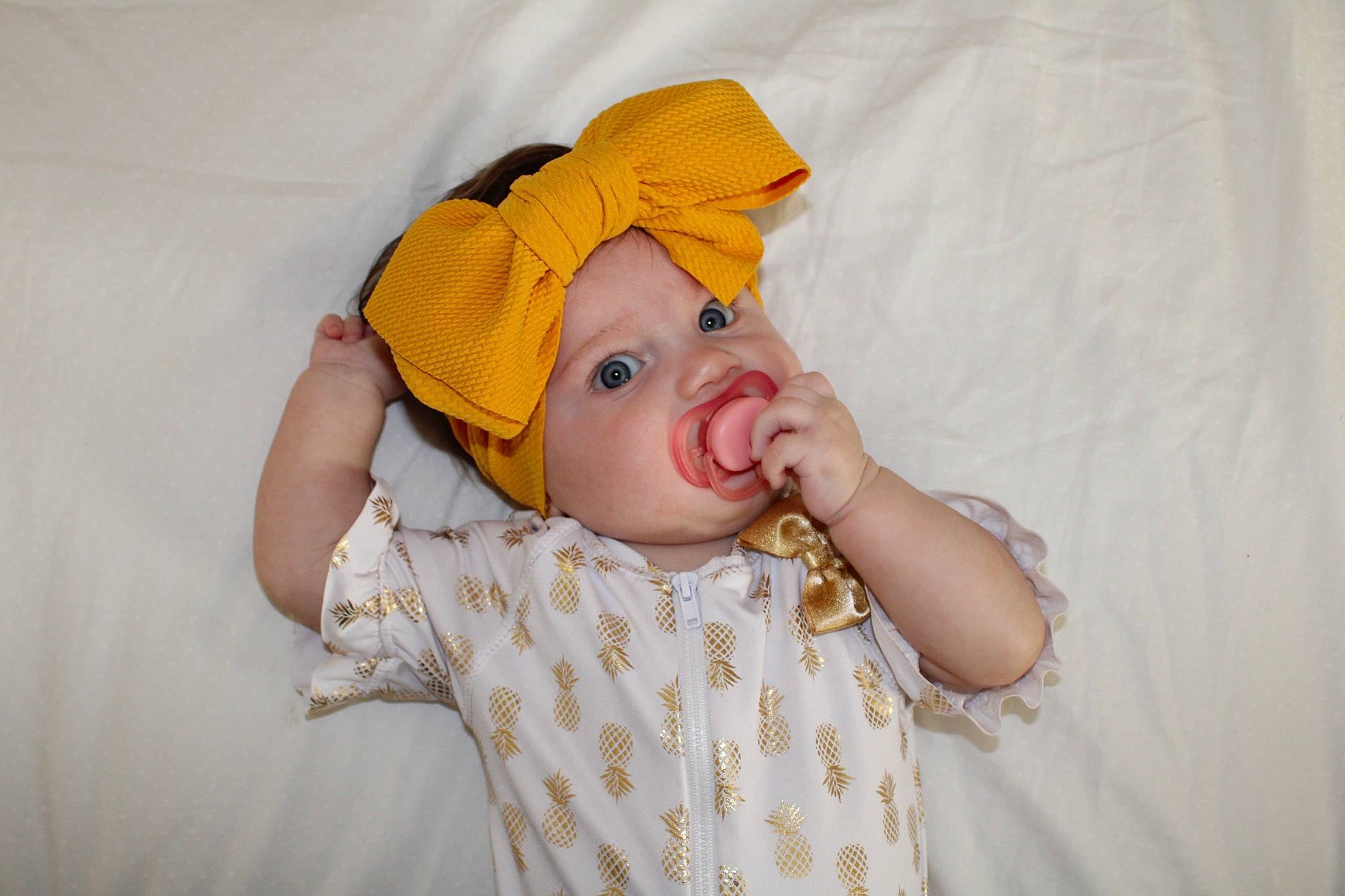 Kassandra joined the competition — help win amazing prizes! baby, baby_sleeping, baby_toddler_clothing, bed, child, comfort, eye, fashion_accessory, fun, gesture, happy, headgear, headwear, linens, pattern, peach, person, portrait_photography, room, sleeve