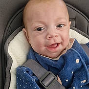 Callie participe au concours pour gagner de l'argent avec cette photo : baby, blue_clothing, car_seat, child, closeup, cushion, cute, face, happy, head, indoor, infant, pattern, person, seatbelt, sitting, smile, star, wearing, young_child