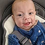 baby, child, smile, blue_clothing, car_seat, seatbelt, indoor, cushion, face, infant, happy, person, cute, young_child, wearing, pattern, star, closeup, head, sitting