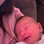 Aurora is registered to the contest to win money with this photo: baby, child, closeup, clothing, comfort, couch, cozy, fabric, face, head, indoors, peaceful, person, pink, resting, sleeping, smile, soft, warm, young