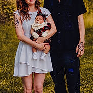 Aurora joined the competition — help win amazing prizes! family, baby, woman, man, outdoor, greenery, nature, smiling, holding, dress, tattoo, shoes, grass, portrait, people, young_adult, infant, casual_clothing, happy, headwear