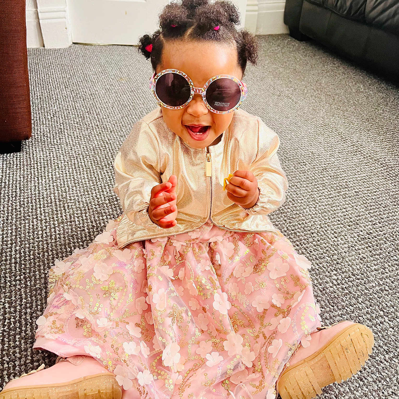 Queen Elizabeth is registered to the contest to win money with this photo: accessories, bodypart, child, clothing, dress, face, female, footwear, furniture, girl, glasses, hair, head, person, photography, portrait, shoe, sitting, sleeve, sunglasses