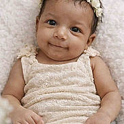 Juniper joined the competition — help win amazing prizes! baby, infant, flower_crown, smile, soft_texture, blanket, cream_color, cute, portrait, young_child, lying_down, happy, baby_clothing, skin, headband, closeup, baby_girl, peaceful, adorable, child