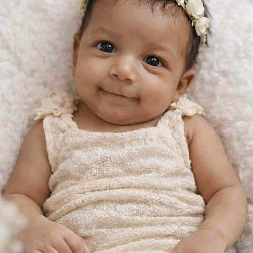 Juniper joined the competition — help win amazing prizes! baby, infant, flower_crown, smile, soft_texture, blanket, cream_color, cute, portrait, young_child, lying_down, happy, baby_clothing, skin, headband, closeup, baby_girl, peaceful, adorable, child