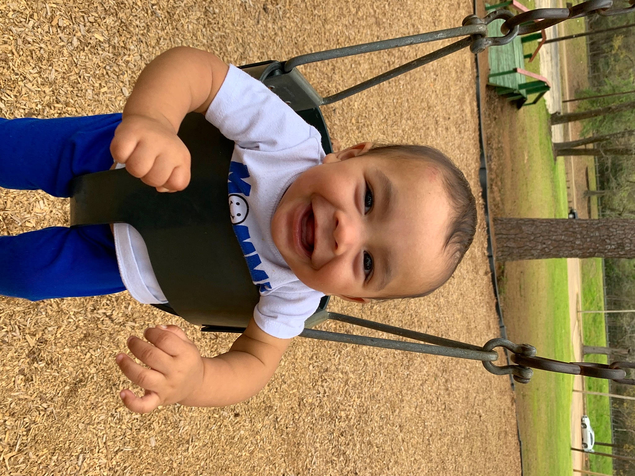Gracen is registered to the contest to win money with this photo: baby, baby_toddler_clothing, child, face, fun, grass, happy, joy, knee, leisure, outdoor_play_equipment, people_in_nature, person, play, recreation, smile, sock, swing, thigh, toddler