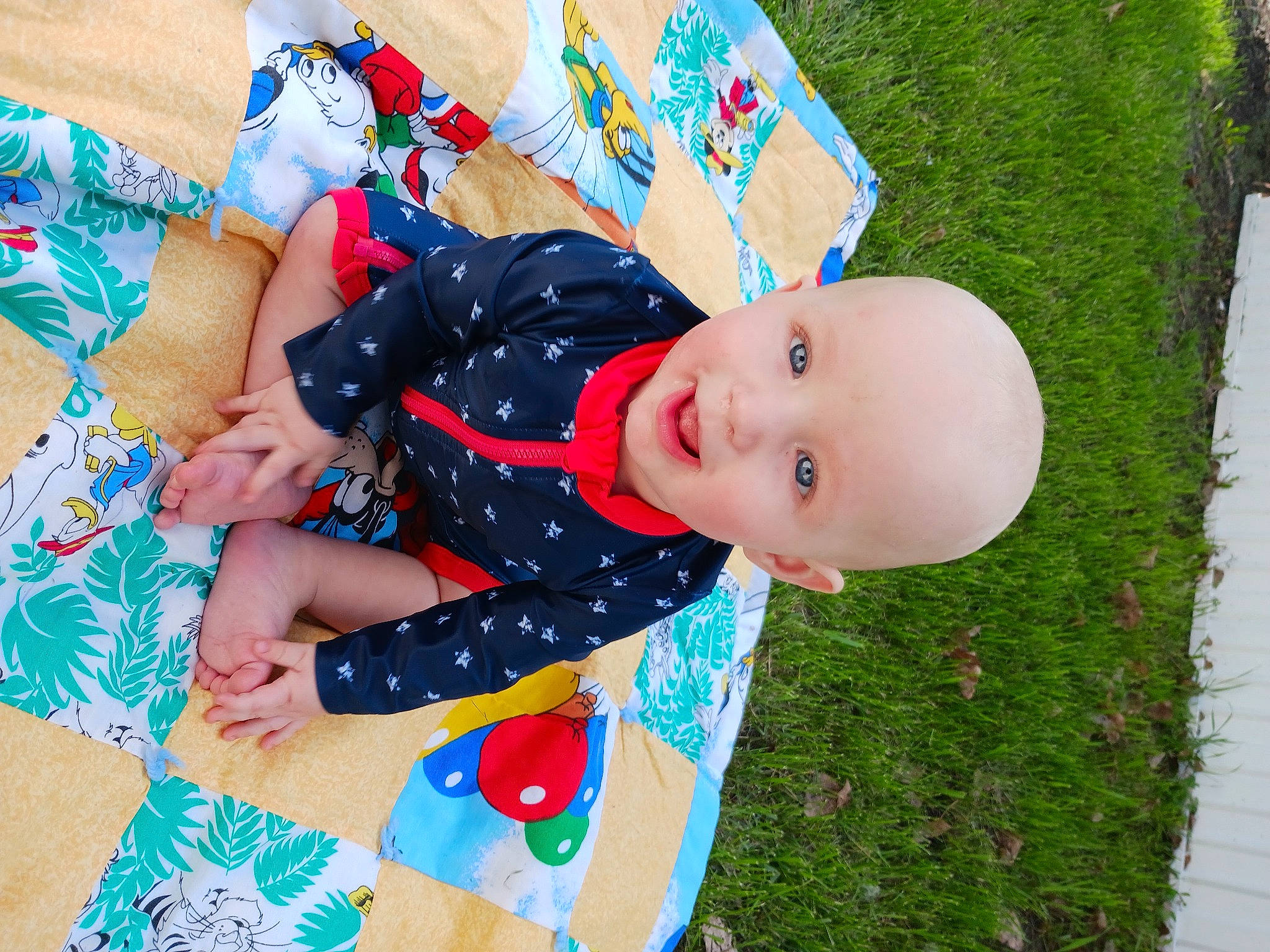 Stephen is registered to the contest to win money with this photo: baby, baby_laughing, baby_products, baby_toddler_clothing, child, fun, grass, happy, hat, linens, pattern, people_in_nature, person, plant, play, sitting, sleeve, smile, toddler, tree