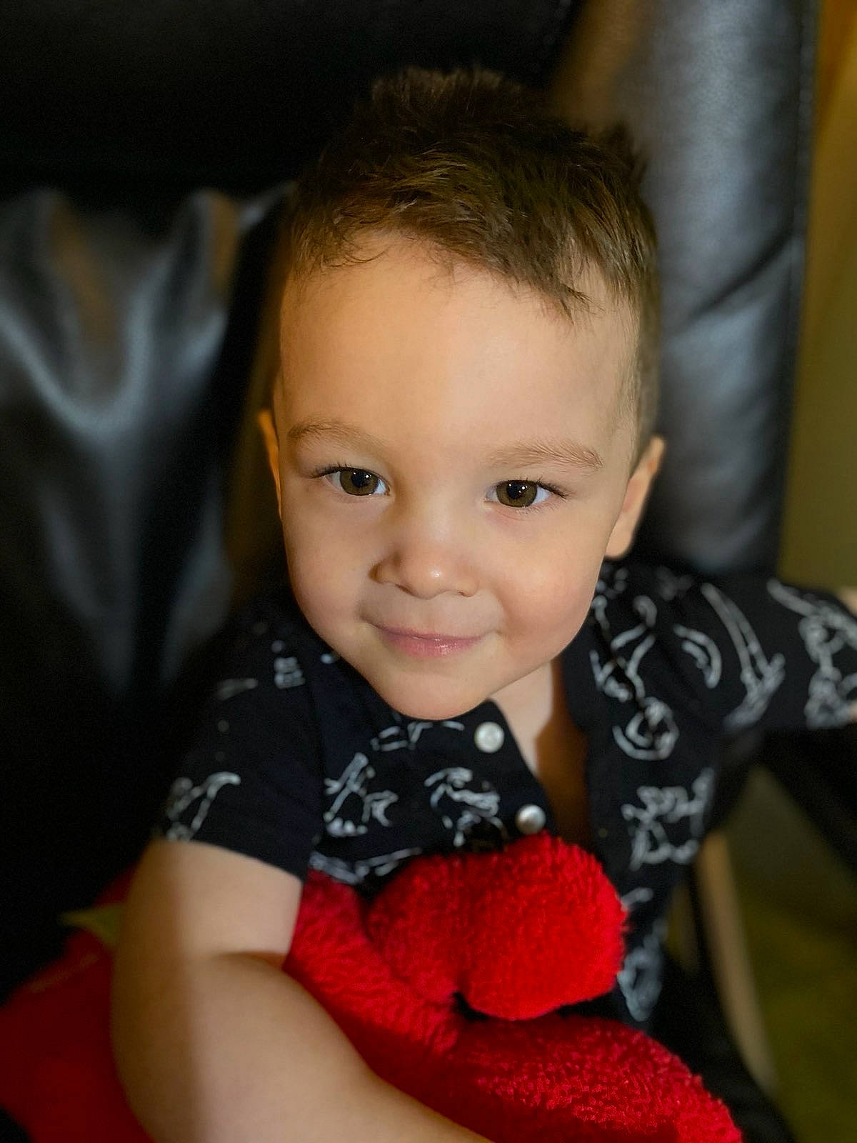 Parker is registered to the contest to win money with this photo: baby, beauty, cheek, child, chin, eye, face, finger, head, iris, joy, lip, mouth, nose, person, red, sitting, skin, smile, toddler