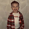 Djulian participe au concours pour gagner de l'argent avec cette photo : toddler, child, smiling, plaid_shirt, white_tshirt, standing, indoor, wall, geometric_pattern, face, happy, casual_clothing, jeans, portrait, person, young_child, hair, expression, floor, snapchat_text