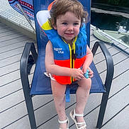 Josie joined the competition — help win amazing prizes! architecture, building, clothing, face, footwear, furniture, head, house, housing, lifejacket, person, photography, porch, portrait, sandal, shoe, shorts, vest, water, waterfront