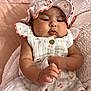baby, infant, child, blanket, hat, clothing, cute, chubby_cheeks, soft, pink, pattern, button, person, portrait, relaxing, indoors, newborn, sleepwear, hands, face