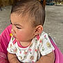 baby, child, infant, onesie, earring, pink, flower_pattern, seat, indoor, wood, concrete, cute, chubby_cheeks, portrait, person, young_child, sitting, side_profile, clothing, adorable
