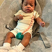 Roxi Love joined the competition — help win amazing prizes! baby, infant, child, pacifier, beads, striped_clothing, white_socks, lace, cushioned_seat, strap, face, hands, legs, indoor, portrait, cute, relaxed, babywearing, childcare, comfort