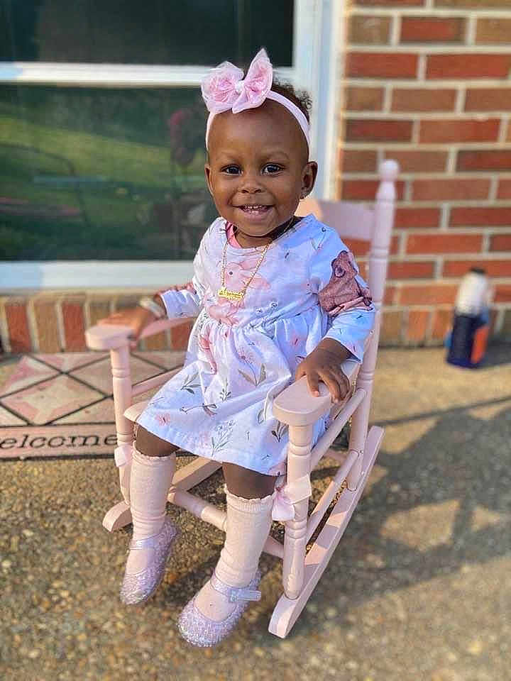 Memorie is registered to the contest to win money with this photo: chair, child, clothing, dress, face, female, footwear, furniture, girl, hair, head, pants, person, photography, portrait, rockingchair, shoe, sitting, sleeve, standing