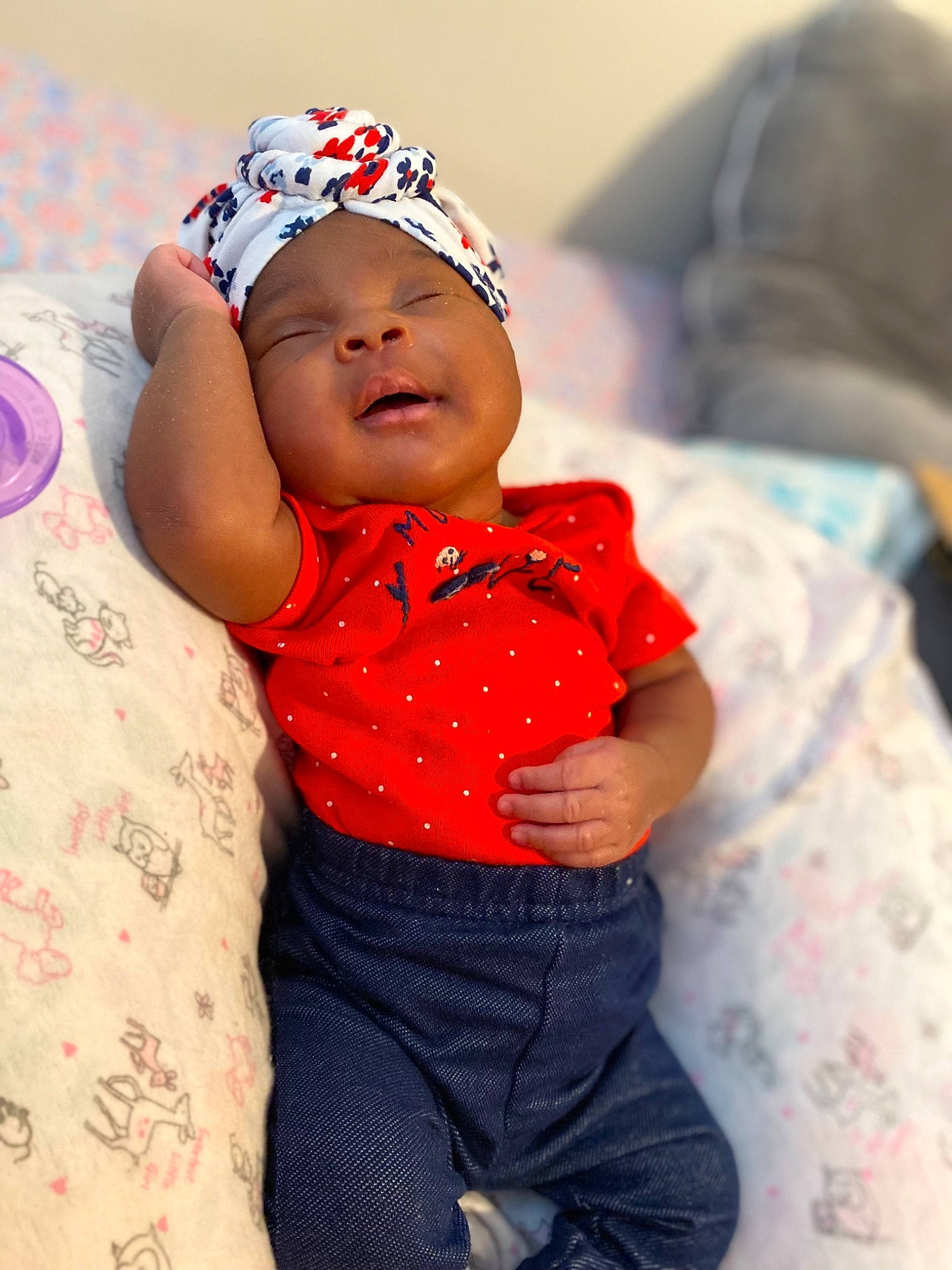 Raelyn is registered to the contest to win money with this photo: arm, baby, baby_toddler_clothing, cap, carmine, child, comfort, eye, fashion_accessory, finger, fun, happy, headgear, headwear, pattern, person, pink, sitting, skin, sleeve