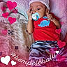 baby, blanket, blue_dinosaur, camo_pants, child, closeup, cute, hashtag, hat, hearts, indoors, infant, love, lying_down, pacifier, patterned_clothing, portrait, red_shirt, soft_texture, text_overlay