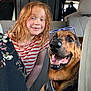 car_interior, casual, child, companion, dog, domestic_animal, friendship, german_shepherd, glasses, happy, indoor, leisure, pet, portrait, red_hair, seat, smiling, striped_shirt, travel, young_girl