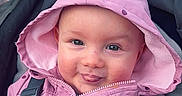Jasmine joined the competition — help win amazing prizes! baby, child, hood, jacket, pink, polka_dot, smile, tongue, stroller, blanket, face, person, outdoor, cute, happy, infant, clothing, seatbelt, warm, portrait