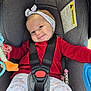 Eïza participe au concours pour gagner de l'argent avec cette photo : baby, car_seat, headband, red_sweater, patterned_leggings, toy, smile, face, child, sitting, safety_harness, warning_label, indoor, person, cute, infant, seat, clothing, accessory, happy