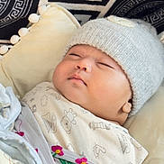 Ammar joined the competition — help win amazing prizes! baby, sleeping, blanket, hat, cozy, cushion, pattern, knitted_hat, infant, cute, indoors, soft, wrapped, peaceful, child, face, resting, warm, clothing, portrait