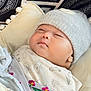 baby, sleeping, blanket, hat, cozy, cushion, pattern, knitted_hat, infant, cute, indoors, soft, wrapped, peaceful, child, face, resting, warm, clothing, portrait