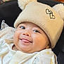 Ammar joined the competition — help win amazing prizes! baby, smile, hat, pom_poms, blanket, indoors, face, child, cute, happy, infant, clothing, portrait, cozy, warm, headwear, expression, wrapped, pattern, background