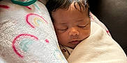 Ramiya is registered to the contest to win money with this photo: baby, sleeping, blanket, pillow, pacifier, rainbow, couch, leather, child, infant, rest, cozy, comfort, face, head, indoors, soft, peaceful, wrapped, toddler